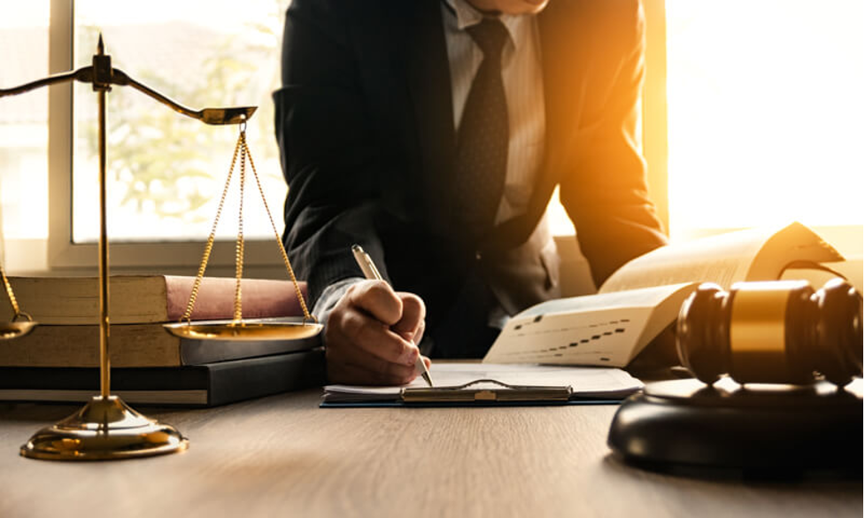 A lawyer in his law office competing the documentation he needs to have translated.